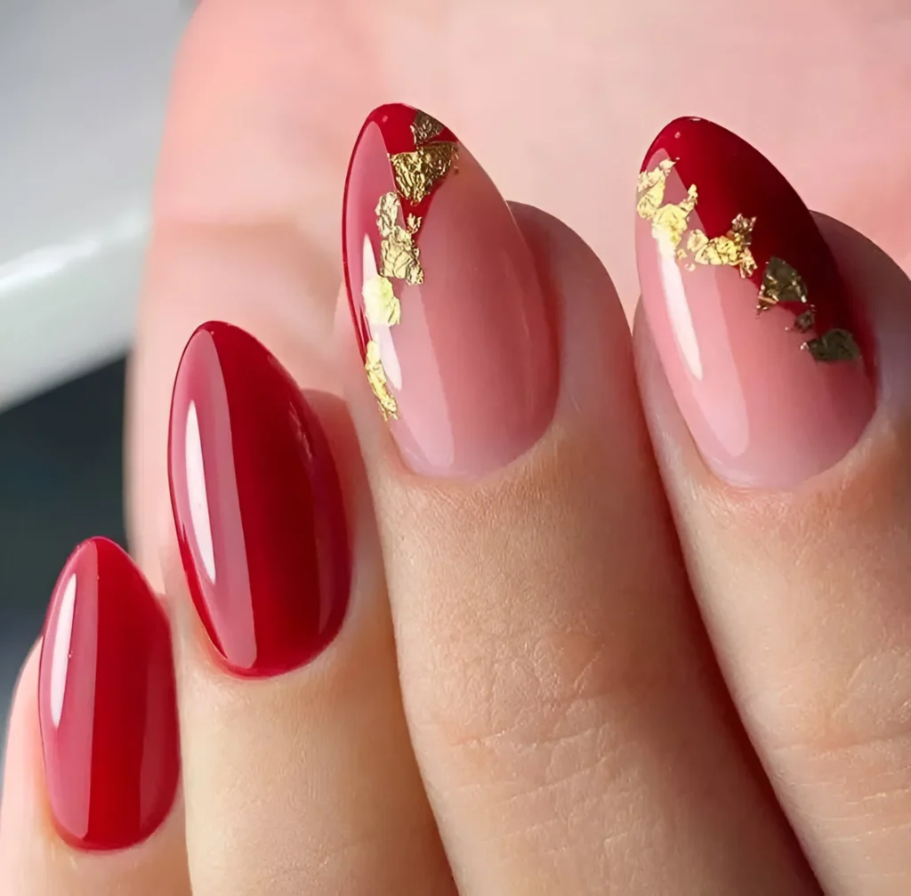 Red and pink ombre nails with gold foil.