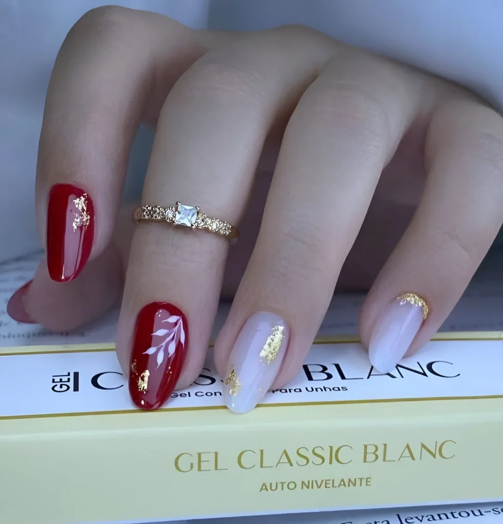 Red and white nails with gold leaf accents  - trendy red nail designs