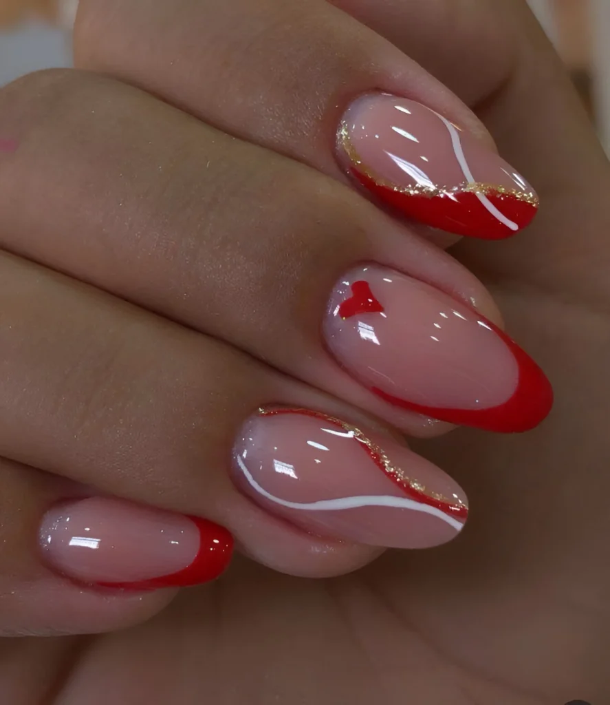 Nude nails with intricate gold, white, and red line art, and heart accent - 2025 - Trending red nail designs