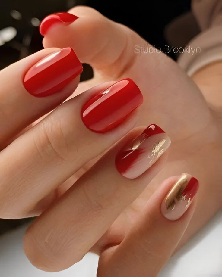 Abstract red, nude, and gold nail art – a unique design for 2025.