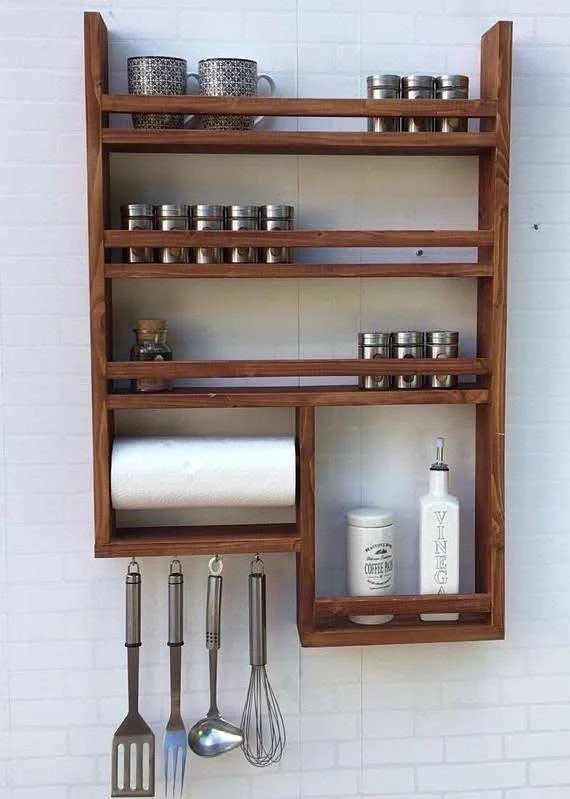 Wall-mounted clear and black utensil holders, organizing forks, knives, and spoons.