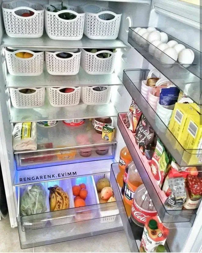 Freezer shelf with various meats neatly stacked in clear, reusable containers.