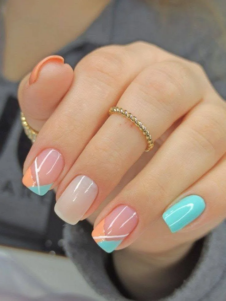 Short nail design with pastel geometric patterns, showcasing a glamorous and modern look.