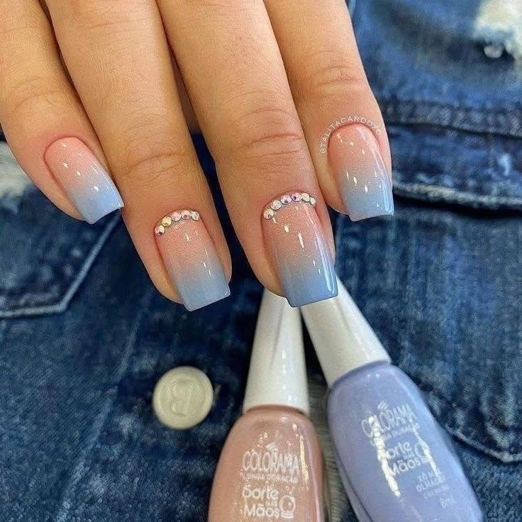 Short dusty rose nails with a glitter accent nail and delicate rhinestone detail, showcasing a glamorous and elegant style.