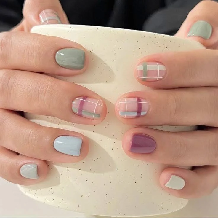 Short nails with a rosy-pink gel French tip, rhinestone accents, and a glitter stripe, showcasing a glamorous and modern look.