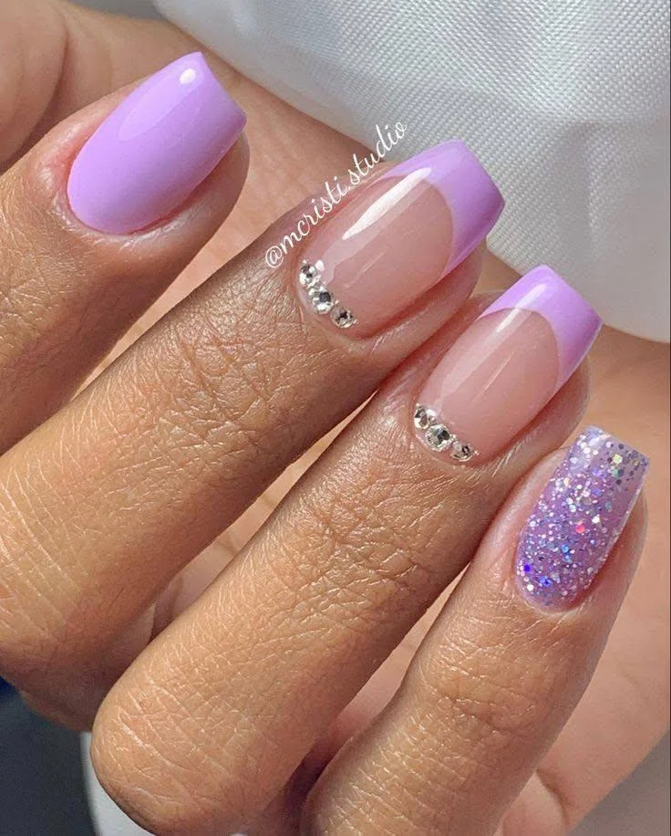 Short dusty rose nails with a gold foil accent nail, showcasing a glamorous and elegant design.