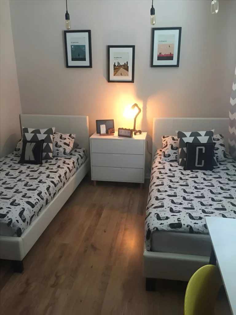 Shared Bedroom with Twin Beds and Initial Pillows