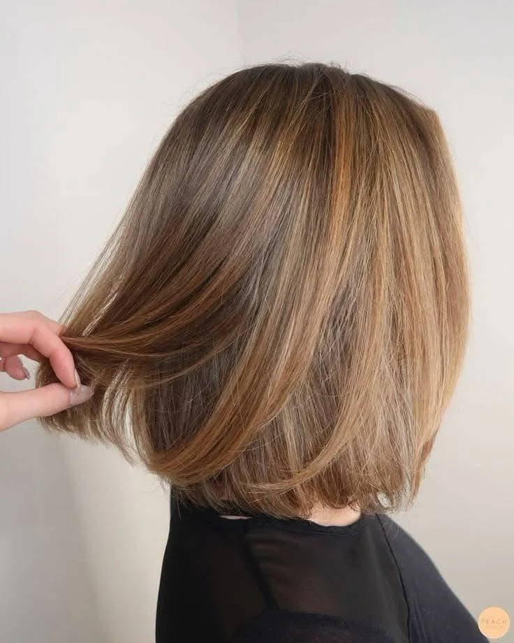 Honey blonde sleek bob, a sophisticated short haircut choice for 2025.