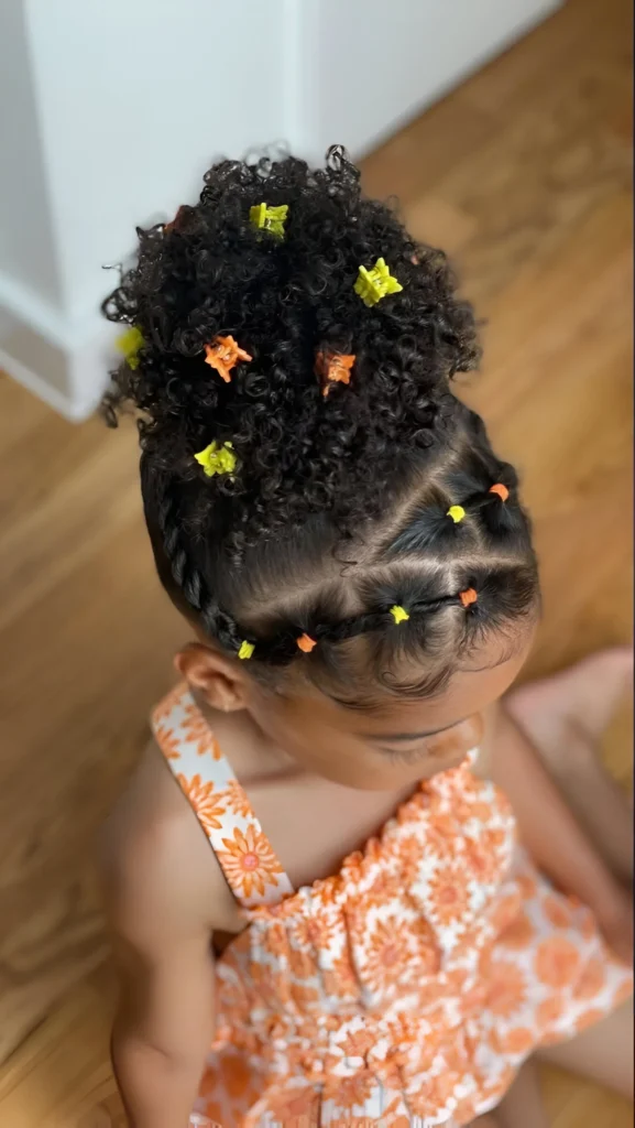 Natural hairstyles for little girls; curly top knot with braids.