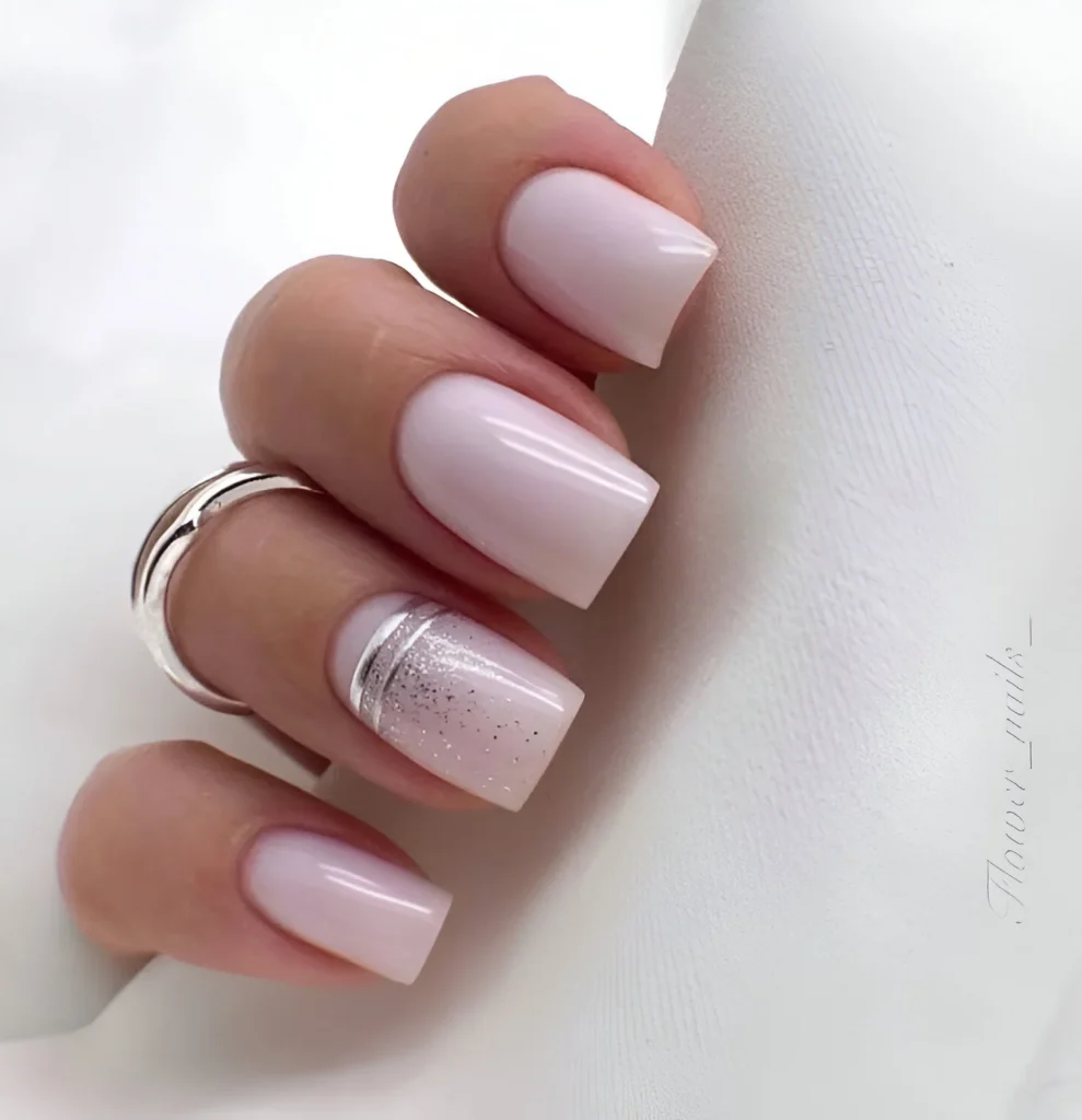 Simple pale pink nail designs with a silver stripe accent nail.