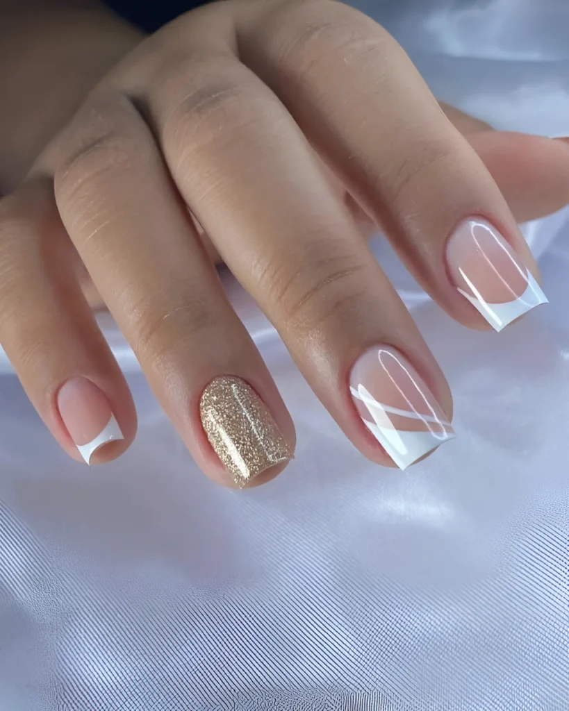 Simple nail designs with gold glitter accent nail and angular French tips.