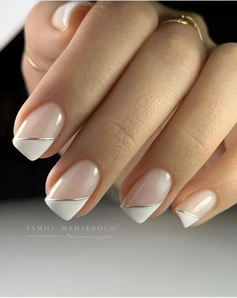 Simple nail designs with angled French manicure and silver line detail.