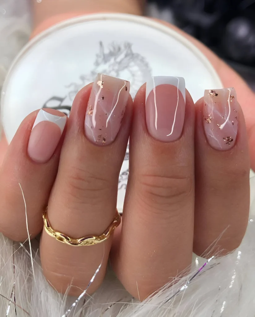 Simple nail designs with French tips and rose gold flake accents.