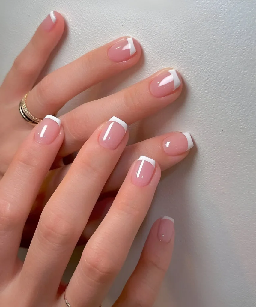 Simple nail designs with varied geometric French manicure tips.