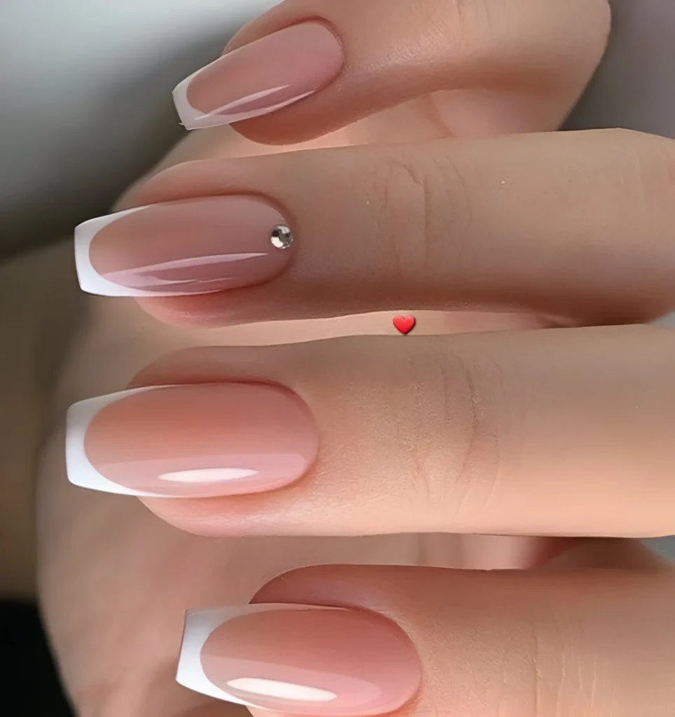 Simple French manicure nail designs with single rhinestone accent.