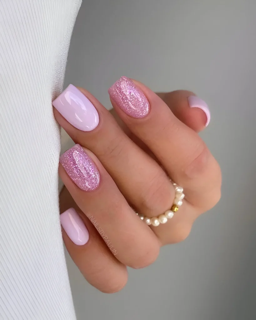 Simple light pink nail designs with matching pink glitter accents.