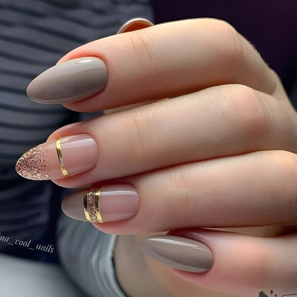 Simple almond nail designs with taupe, gold stripe, and glitter accents.