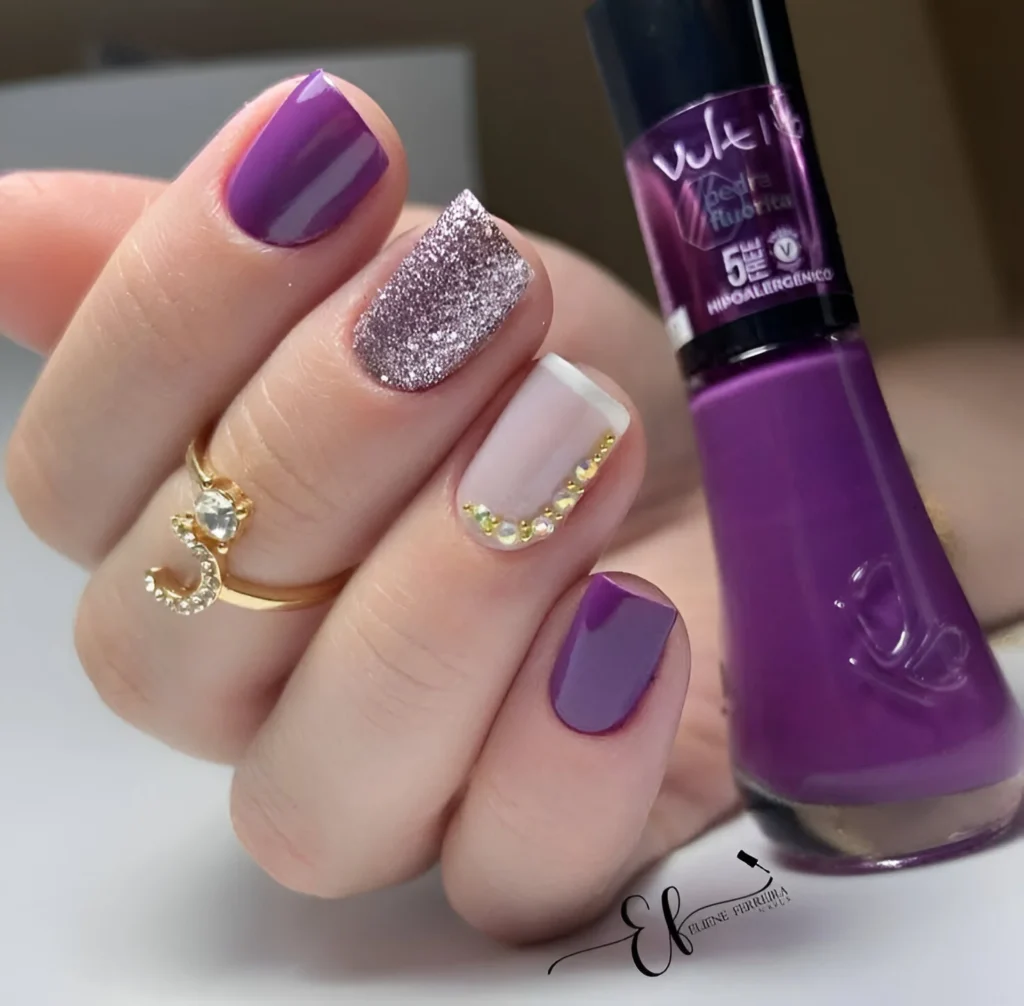 Elegant purple nails with silver glitter and crystal details.