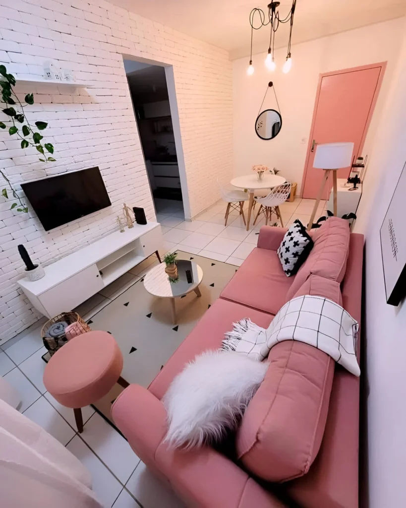 Small living room with playful pink decor and textured wall.