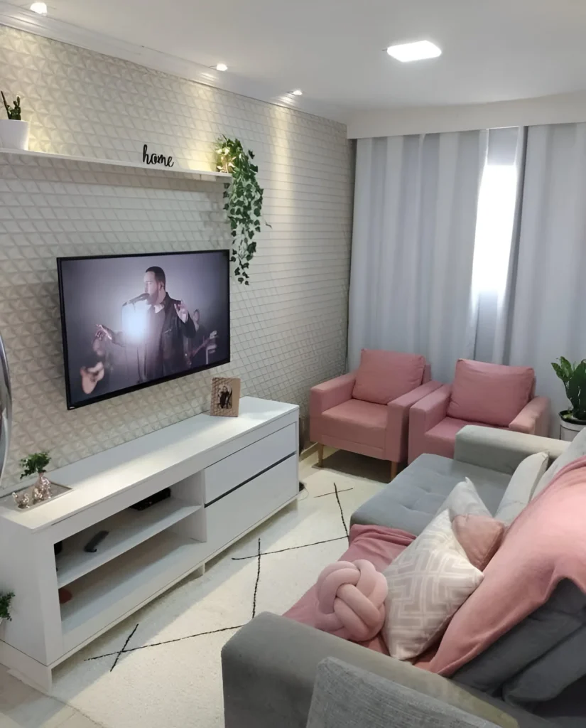 Small living room with textured wall and pink accent chairs, cozy home decor.