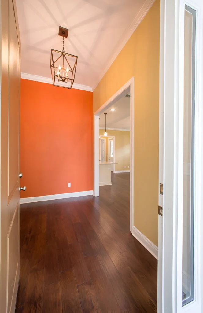 Bright orange accent wall in home entry.