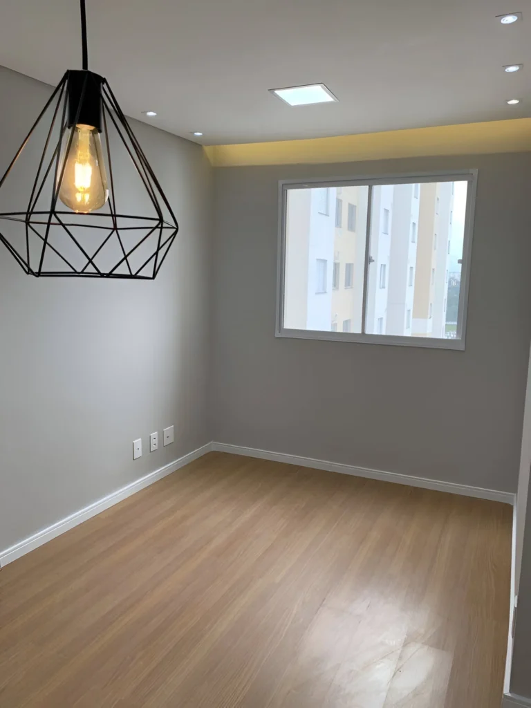 Soft gray accent wall behind modern lighting.