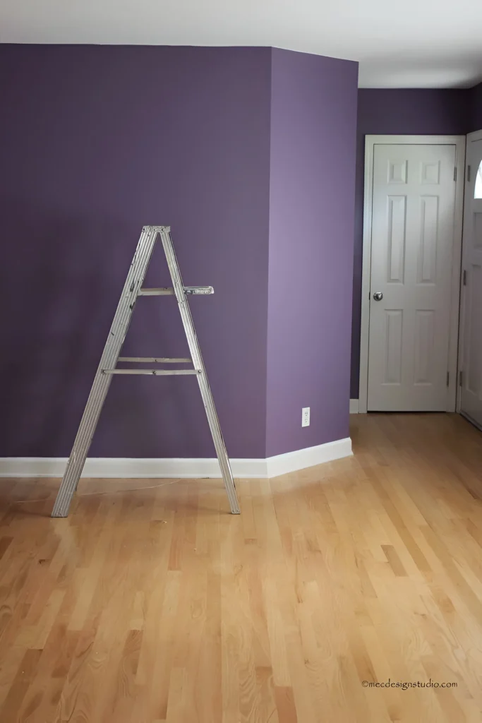 Purple accent wall in room corner.