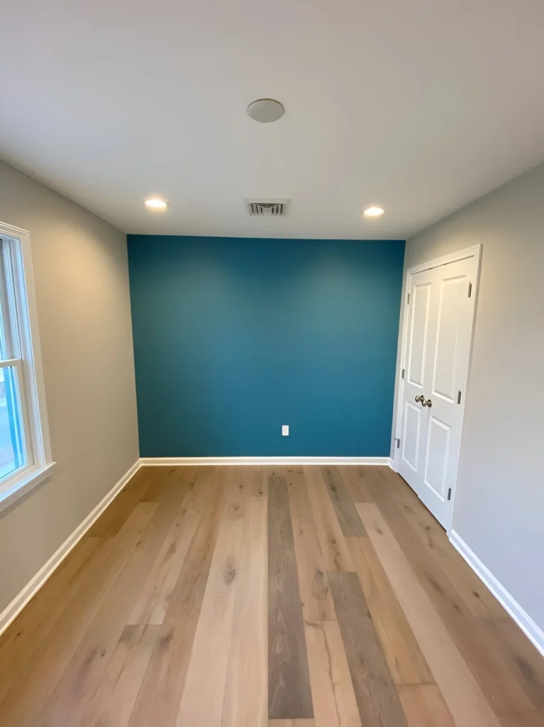 Teal accent wall in a neutral room.