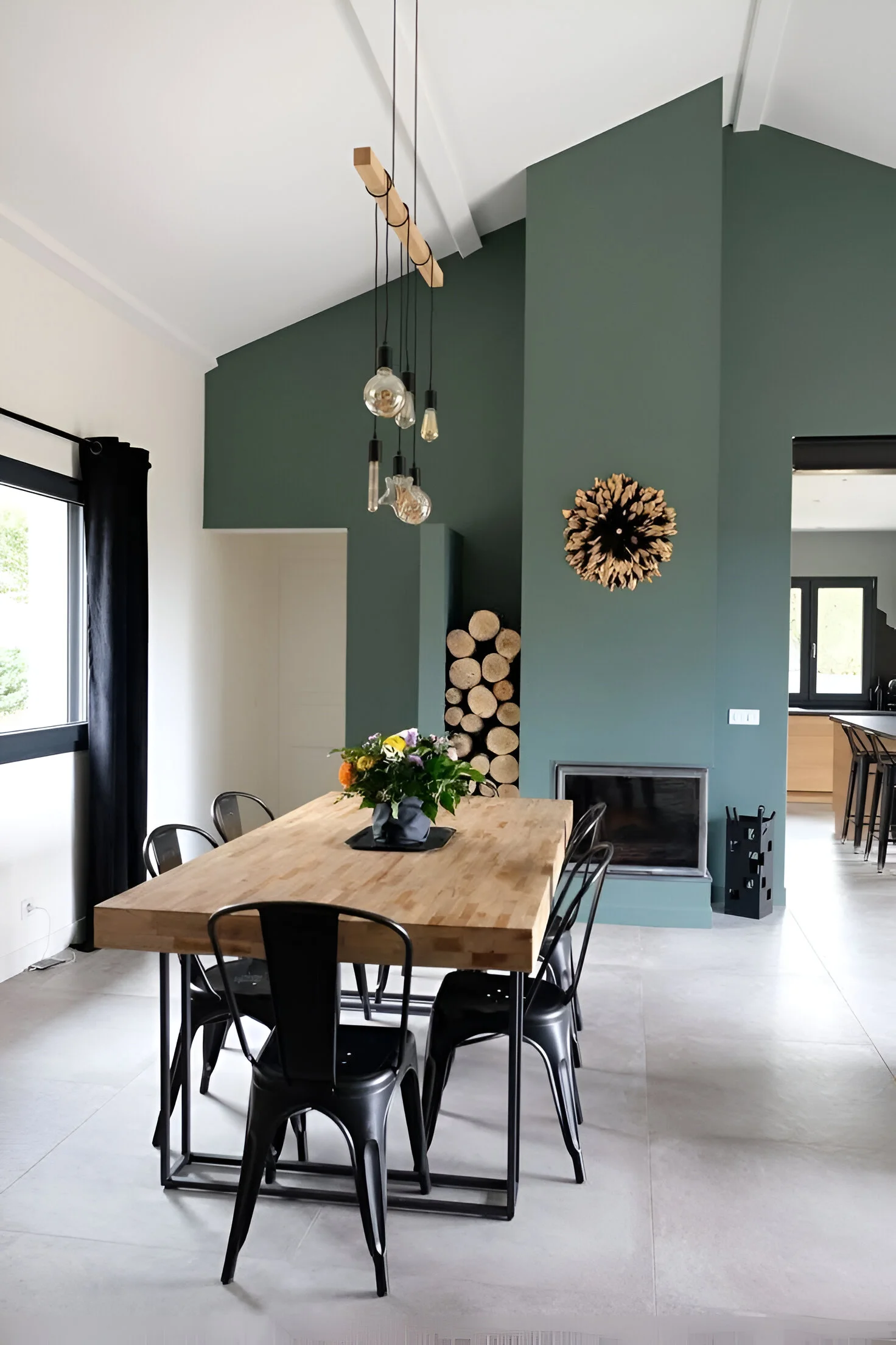 Angled green accent wall in dining area.