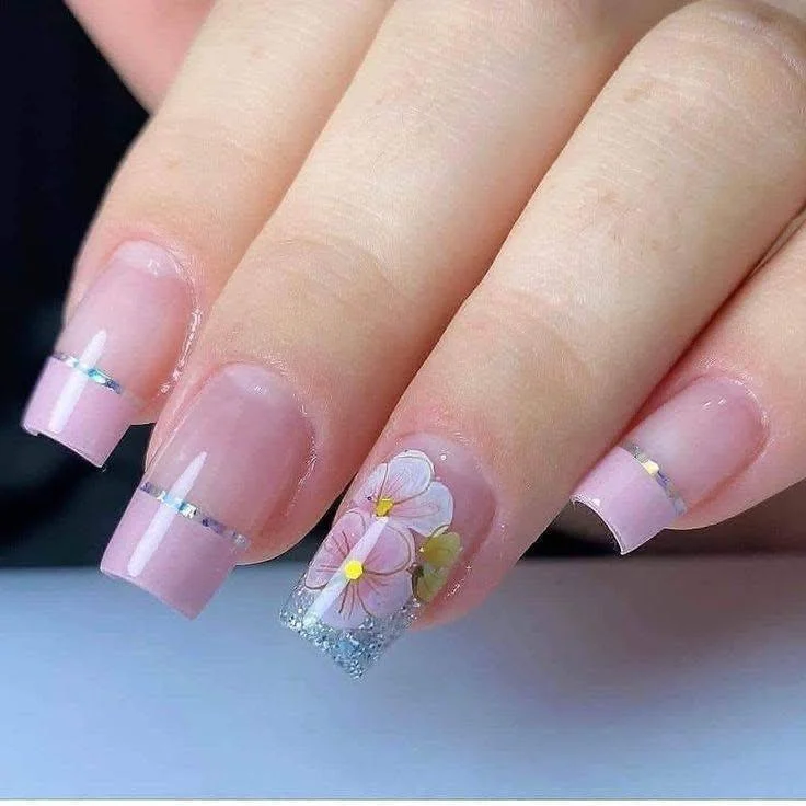 Nude pink nails with silver stripes and hand-painted floral accent. trendy nail designs