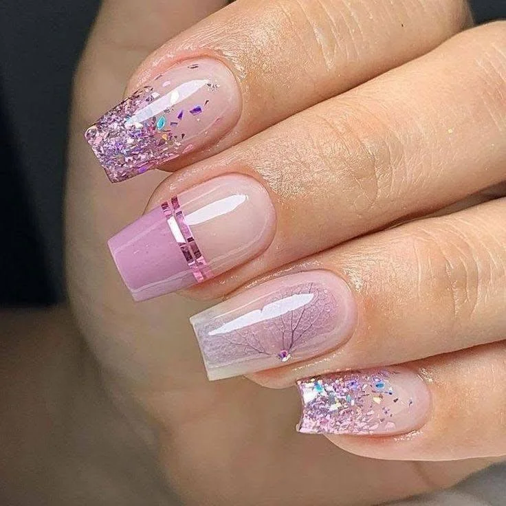 Mix-and-match nail design with glitter, stripes, flowers, and rhinestones.