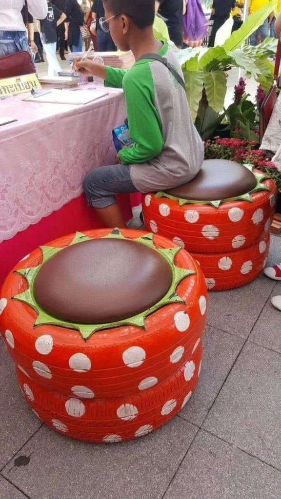 Two upcycled tire seats painted to look like strawberries. upcycling old tires