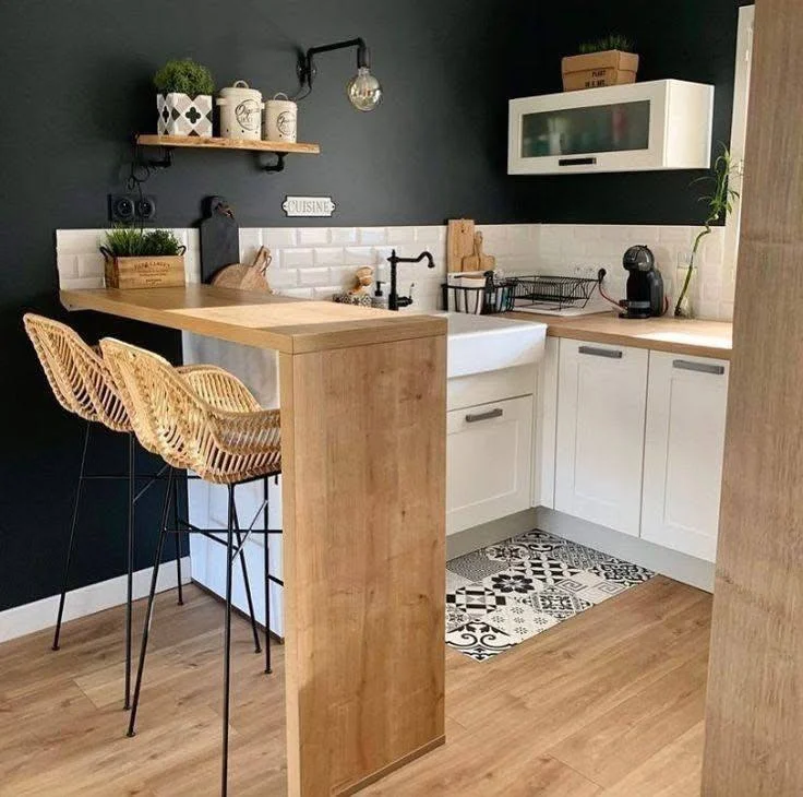 Bohemian style kitchen with wood bar and rattan stools.