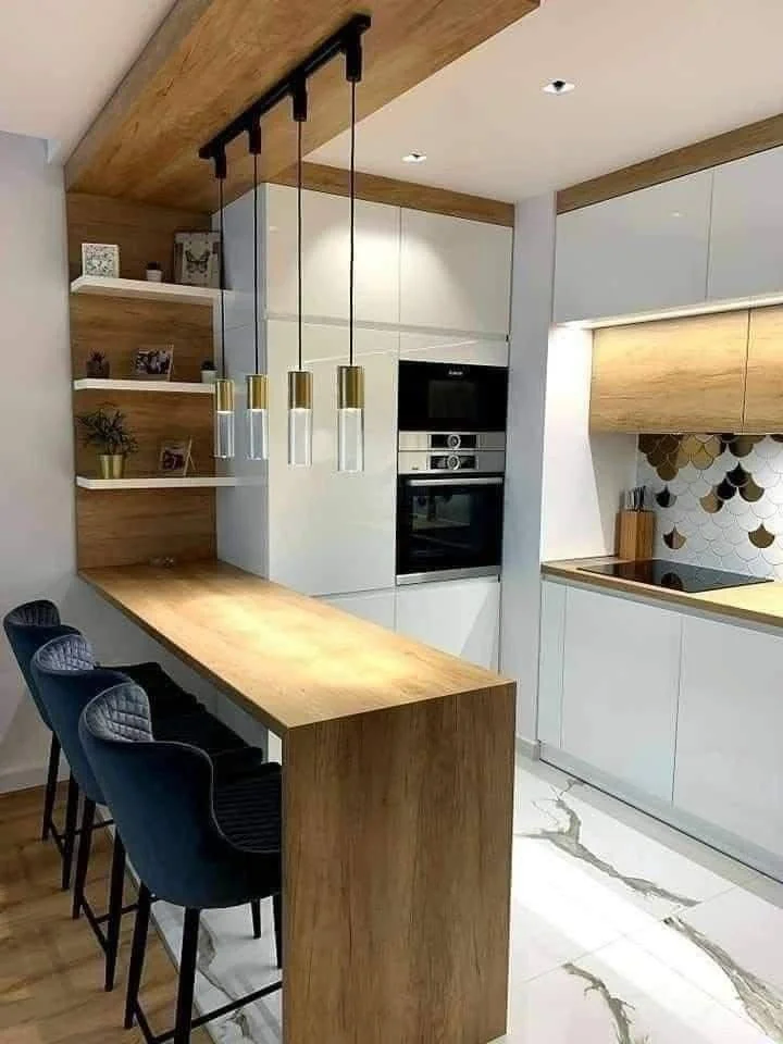 Modern kitchen with wood waterfall edge bar.