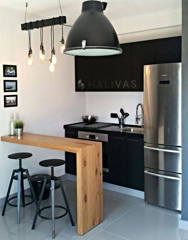 Industrial style kitchen with wood slab bar.