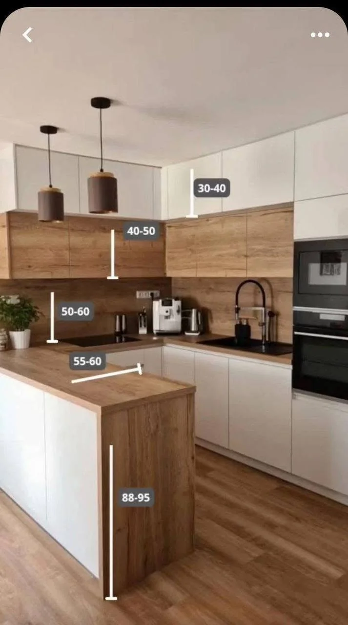 Modern kitchen with two-toned wood and white bar.