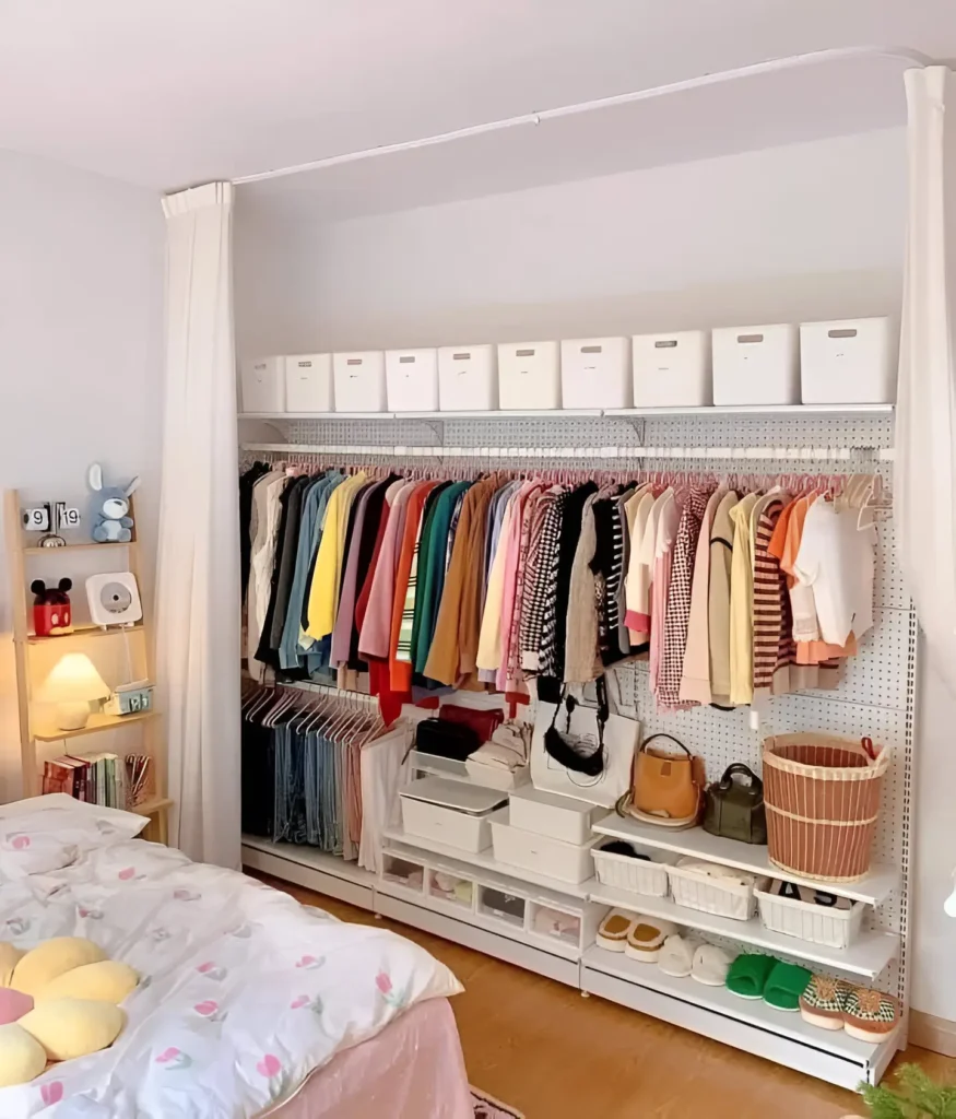 Open closet system with rods, shelves, and drawers in a bedroom.