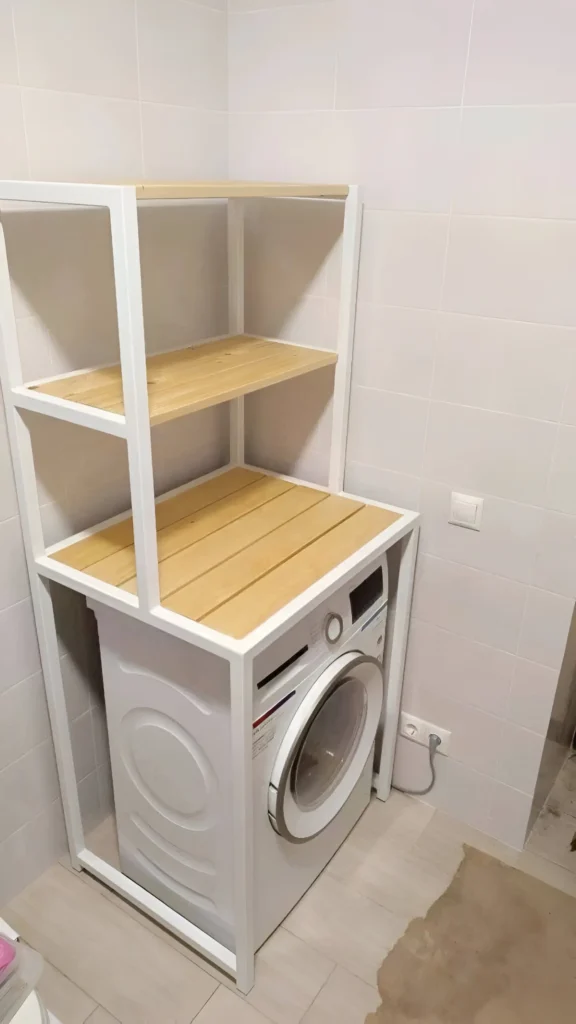 Shelving unit positioned over a washing machine in a laundry room.