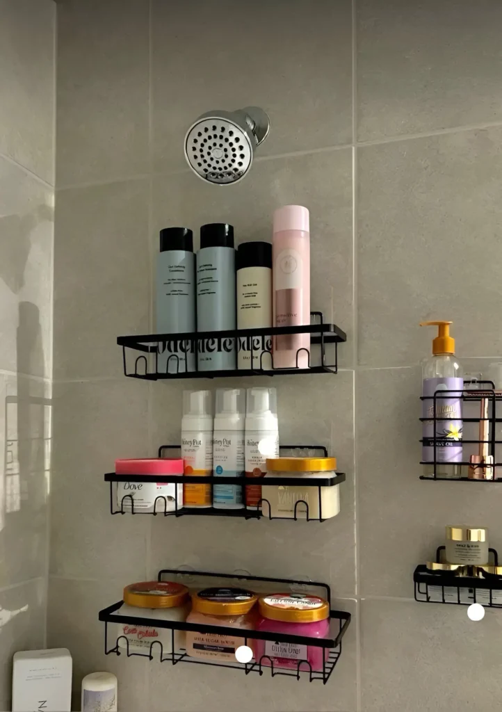 Wall-mounted shelves in a shower holding various toiletries.

