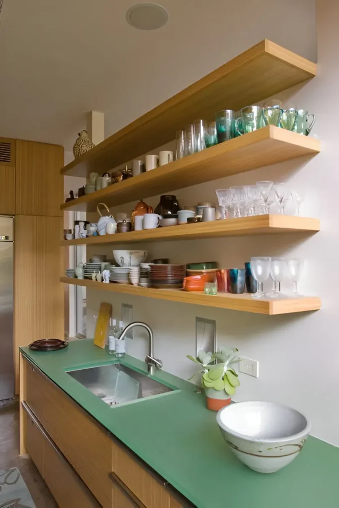 Kitchen with long, open shelves above the countertop for dish and glassware storage.