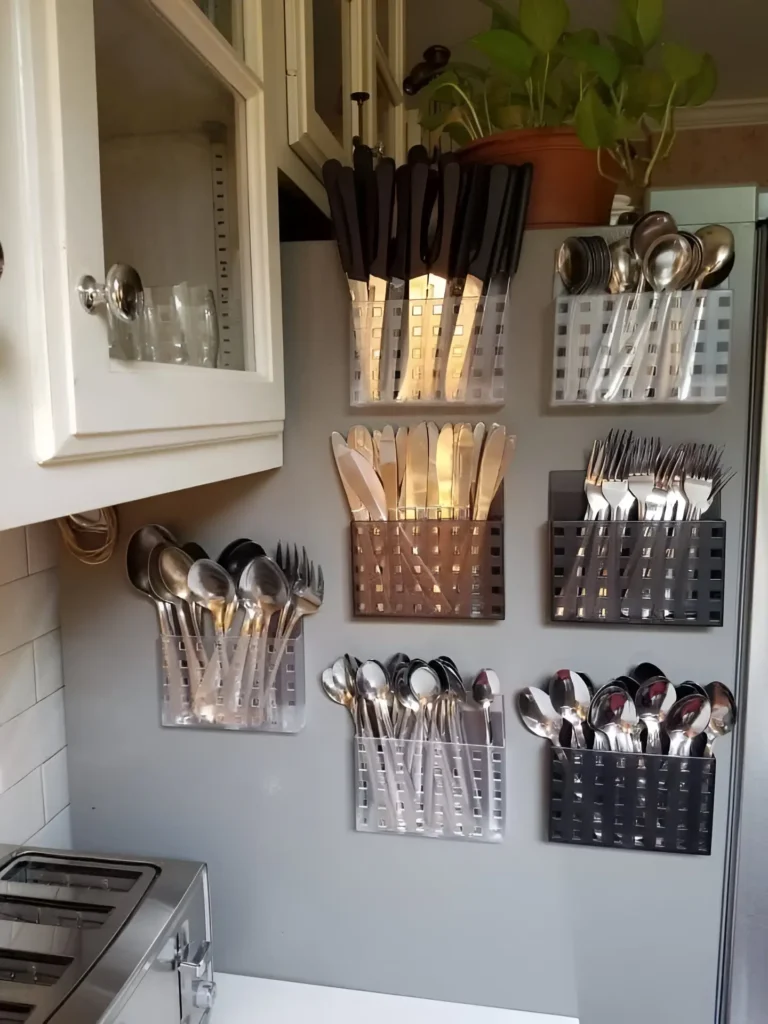 Wall-mounted cutlery holders in a kitchen, in various colors.