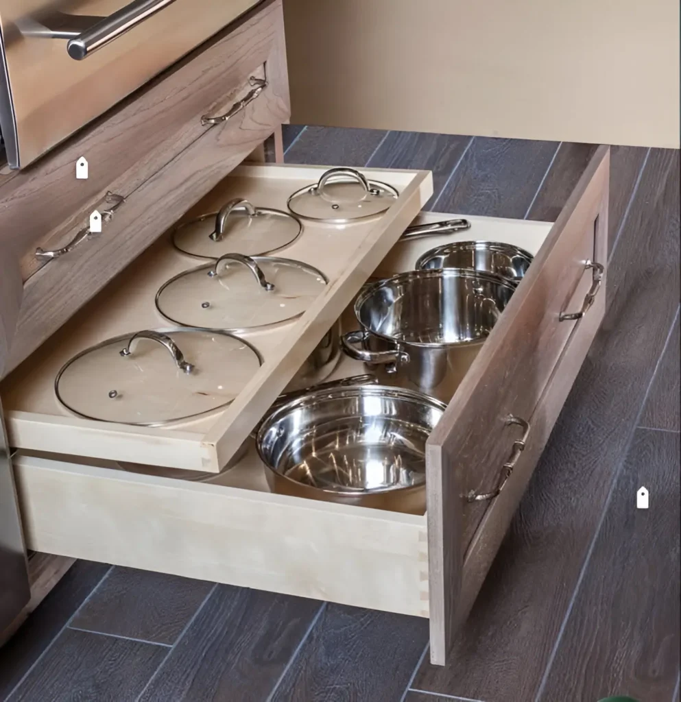 Two-tiered kitchen drawer organizing pots and lids separately.