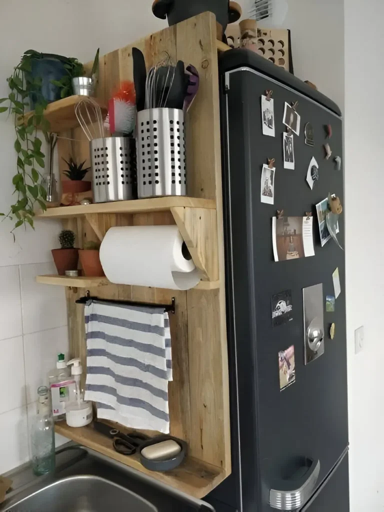 Multi-tiered shelf attached to the side of a refrigerator in a kitchen.