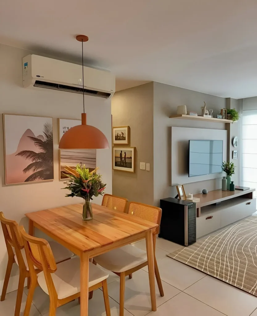 Small dining and living area with warm wooden furniture, pendant lighting, and wall-mounted shelves.