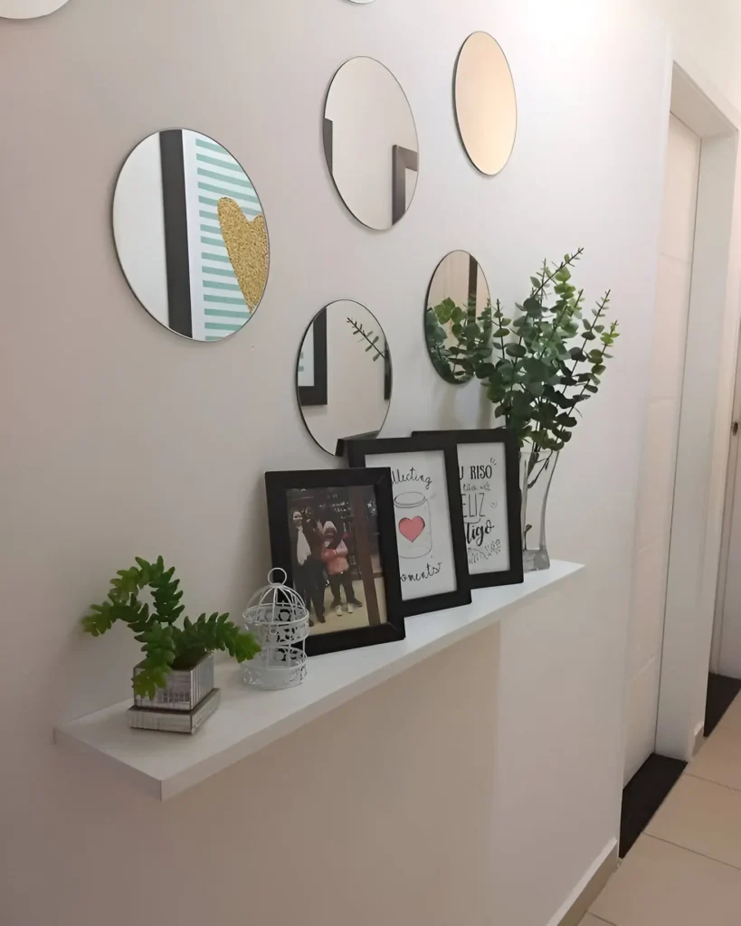 Modern hallway with a round mirror gallery wall, floating shelf, and decorative accents.