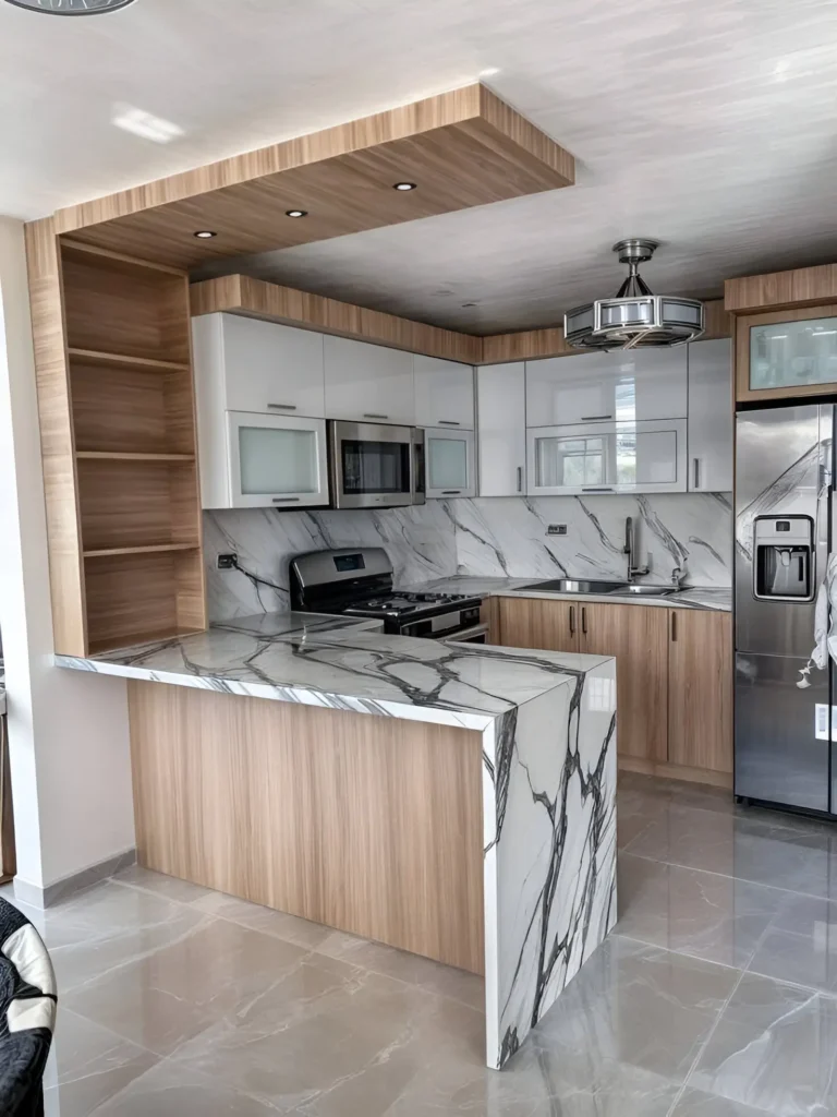 Kitchen featuring waterfall marble countertops, wood cabinetry, and modern lighting.