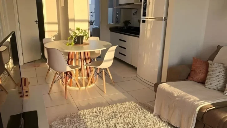 Small apartment with a round dining table, cozy seating, and natural sunlight creating an airy and inviting atmosphere. Interior Design Tips