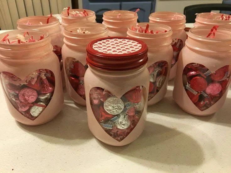 DIY Painted Mason Jars with Heart Cutouts for Home Decor.