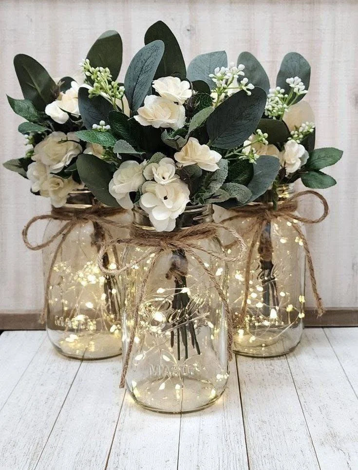 DIY Mason Jars with Fairy Lights, Eucalyptus, Hydrangea, and Roses.