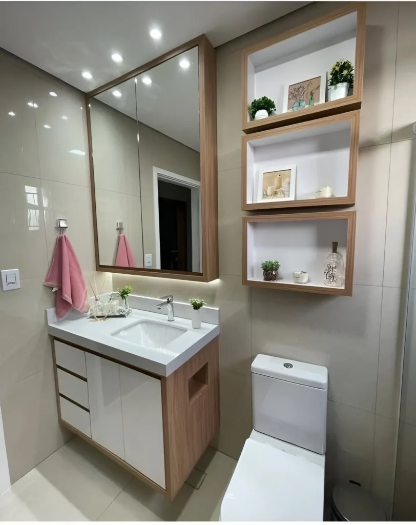 Modern small bathroom with wood and white floating vanity, wall-mounted open shelving, and large mirror.